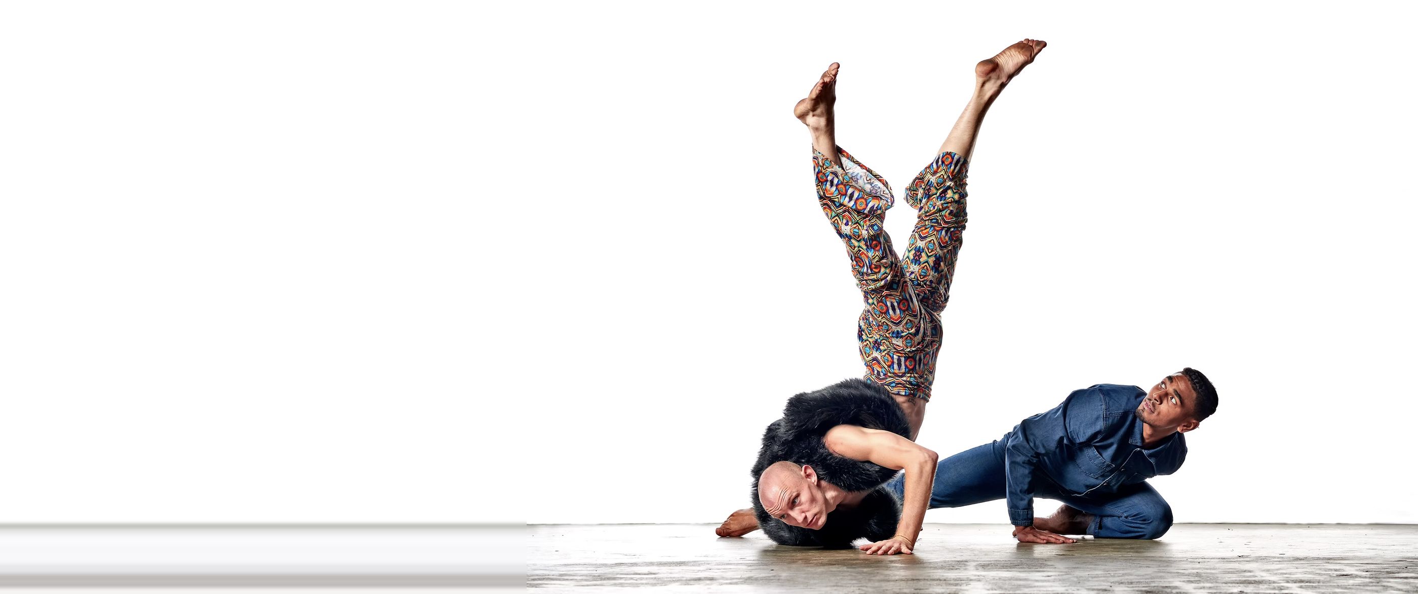 Two dancers in an inverted duet against a white studio — Iris Company